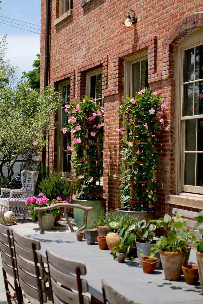 1 red brick loft terrace roof garden trees flowers dining set apartment city