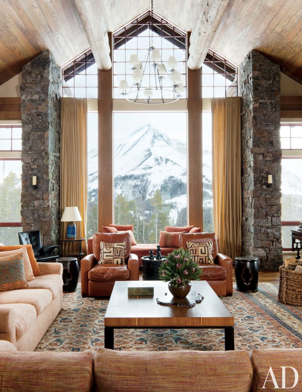 rustic luxury living room persian carpet leather sofas stone wall mountain snow ski lodge decor better decorating bible blog snow lodge