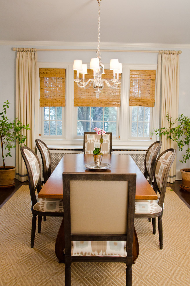 Dining room with roman blinds and chandelier.