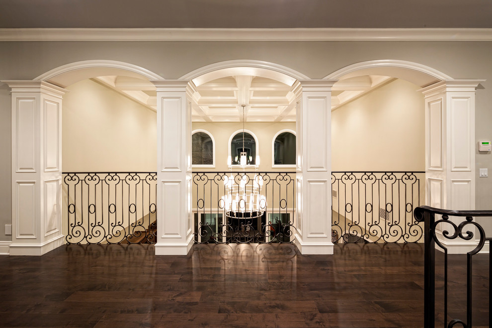 mediterranean-hallway open to below wrought iron railing dark hardwood strip floors chandelier