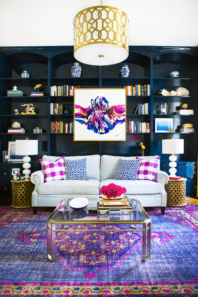 abstract artwork purple persian rug built in bookshelves dark blue how to hang artwork in your home indigo family living room space design shop-room-ideas