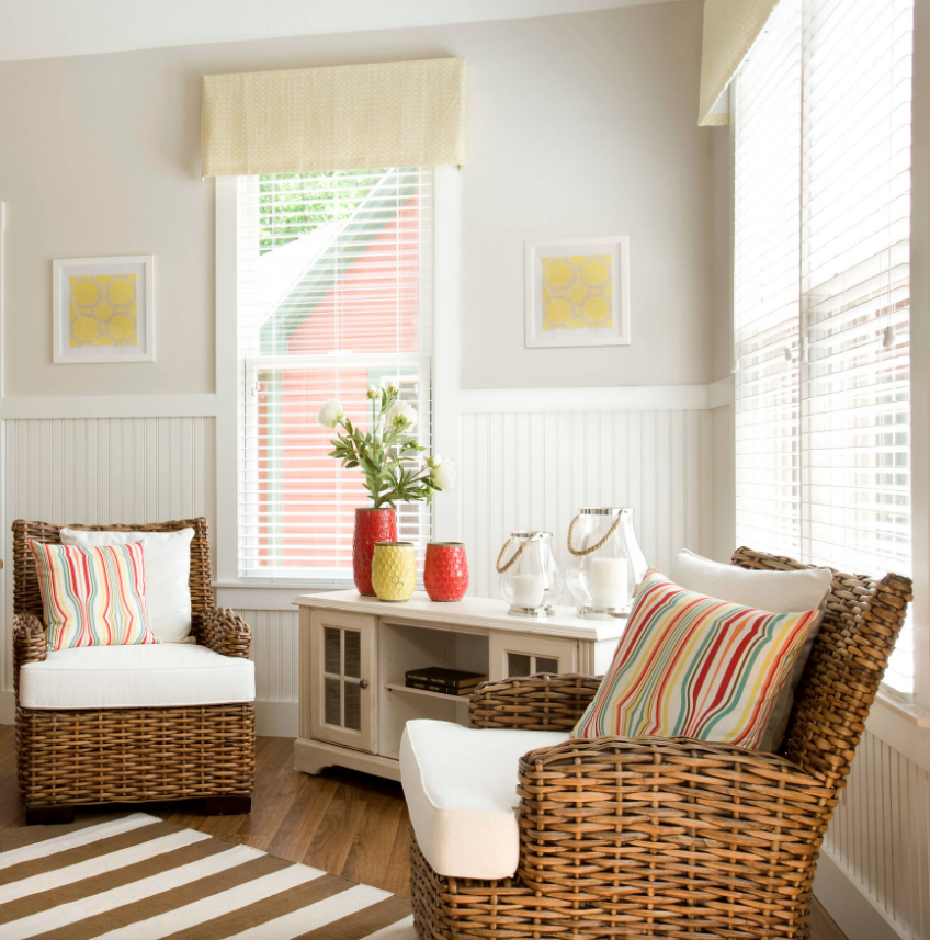 Two chairs and windows with roman blinds.